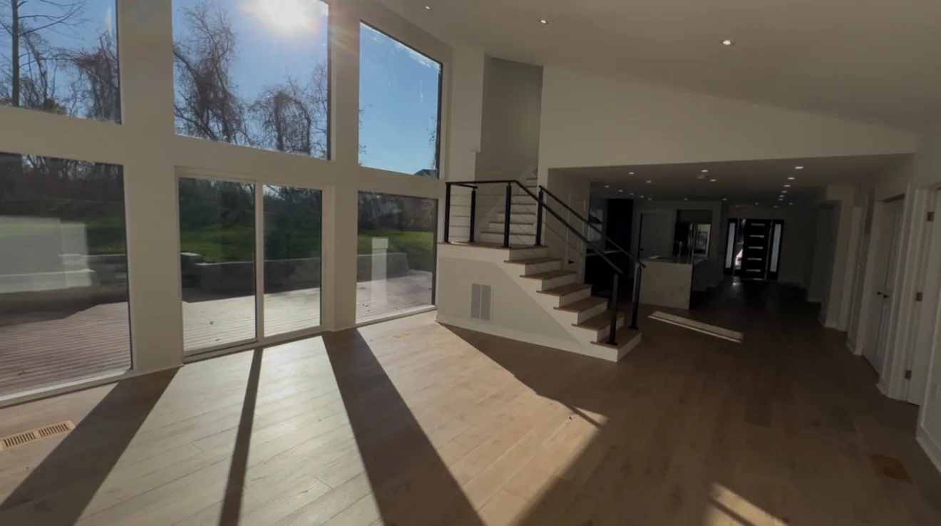 Wide view of finished great room with kitchen visible
