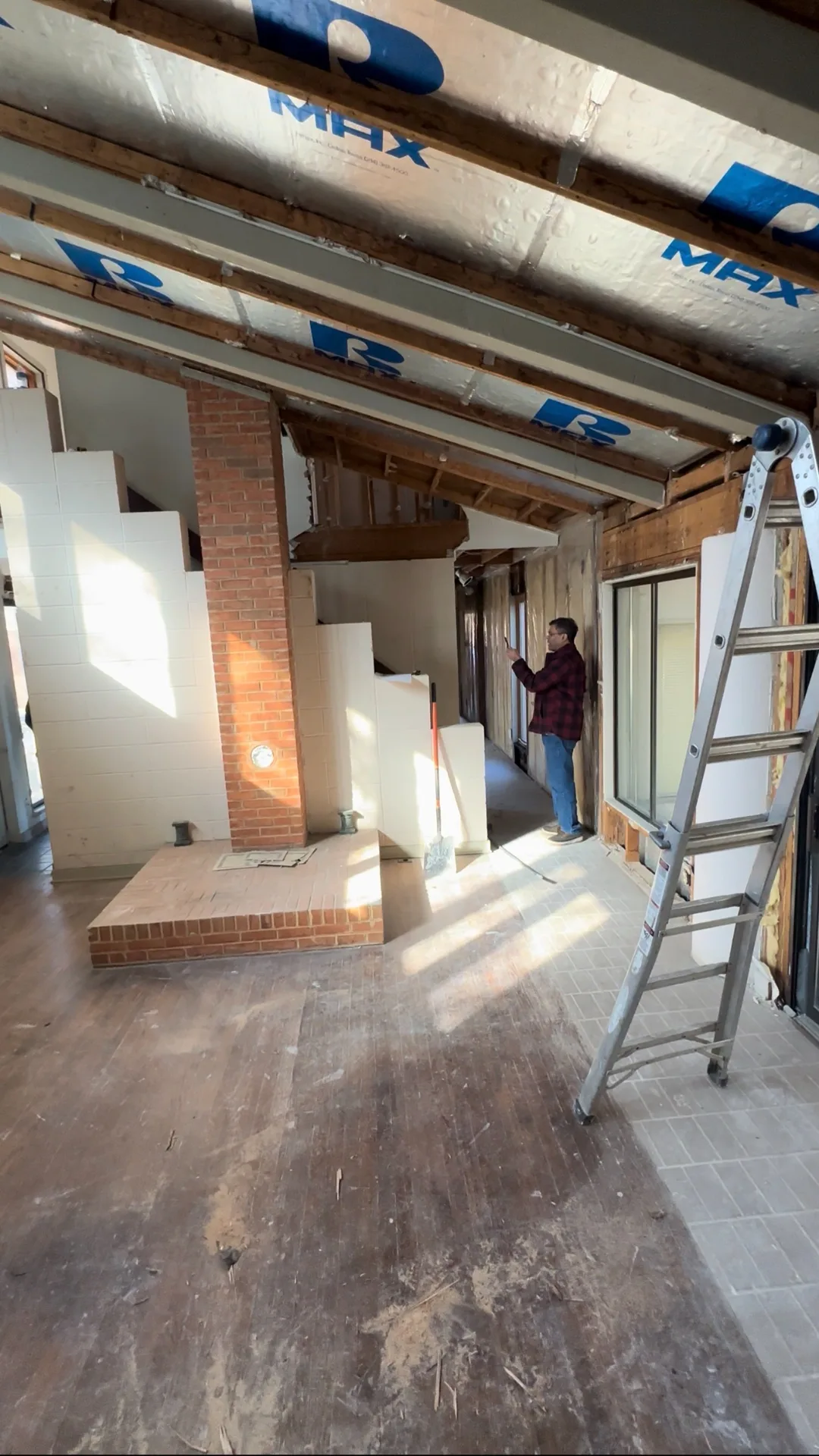 Brick chimney column with ladder before demo
