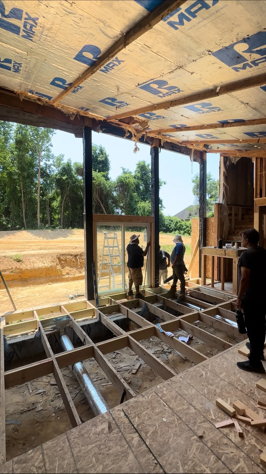 Floor-to-ceiling door wall framed in addition