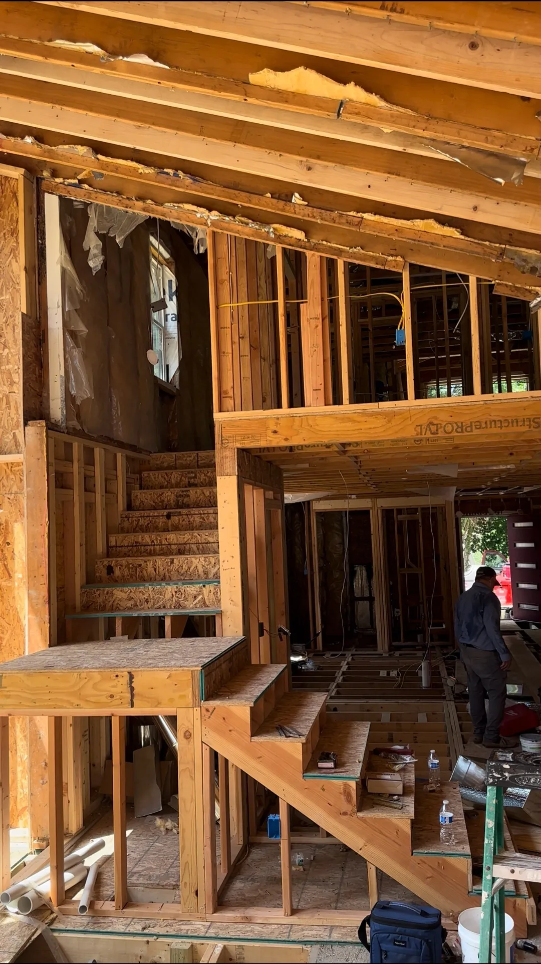 Open-stair stringer mid-build with floor void