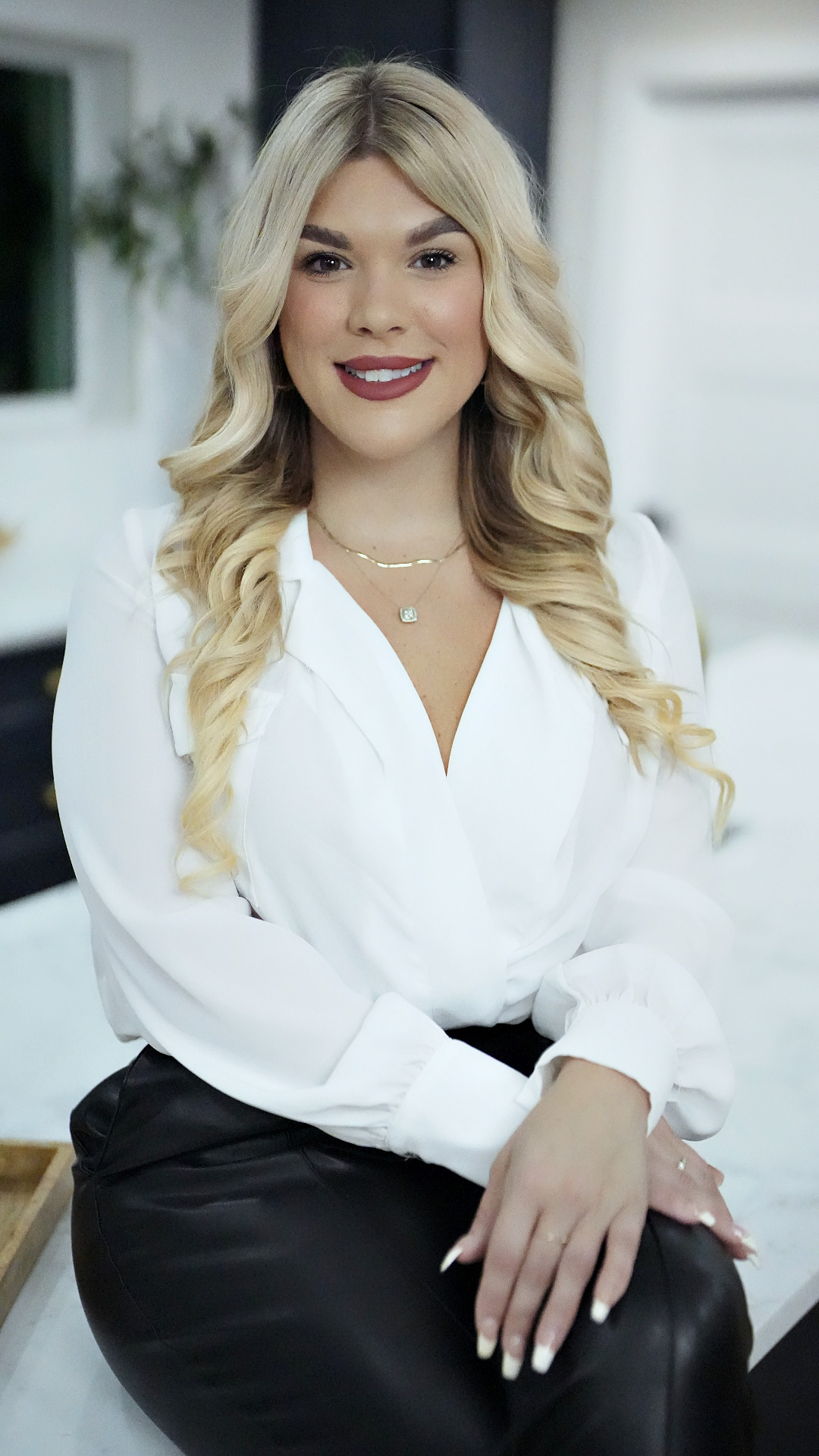 Samantha Allen in a white blouse, kitchen interior